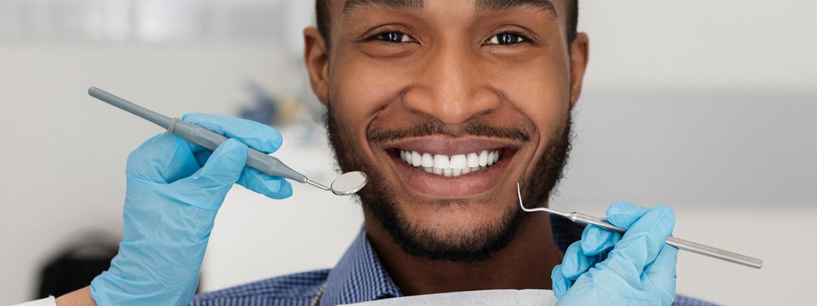 Afro American man smiling during dental examination